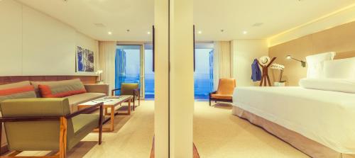 a bedroom with a bed and a living room at Emiliano Rio in Rio de Janeiro