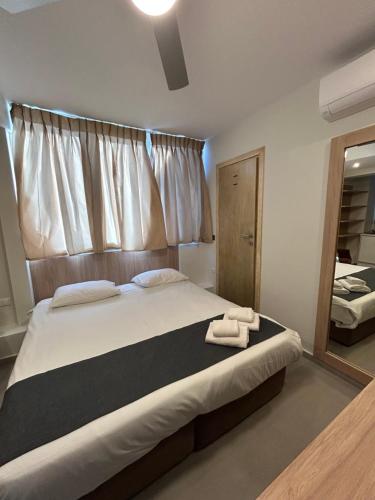 a bedroom with a large bed with two towels on it at Perea Hotel in Perea
