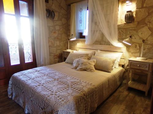 a bedroom with a bed with a teddy bear on it at Alegria Villas Complex in Vasilikos
