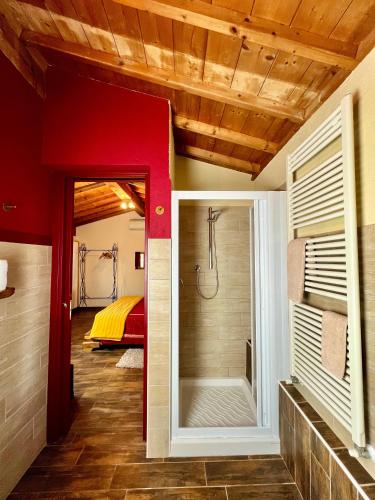 a bathroom with a shower and a bedroom at Corte Tamellini in Soave