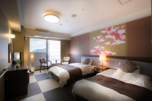 a hotel room with two beds and a window at Hotel Sekumiya in Obama