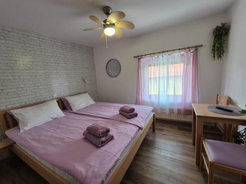 a bedroom with a large bed with towels on it at Penzion TTT in Bled