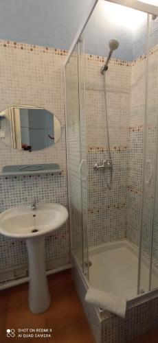 a bathroom with a shower and a sink at Hôtel de Paris - Narbonne in Narbonne