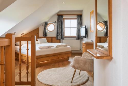 a bedroom with two beds and a mirror at Bloberger Hof in Salzburg