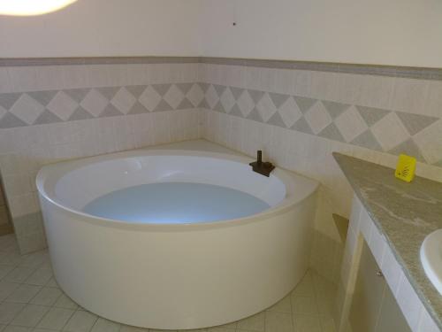 a bath tub in a bathroom with a sink at Gaia - Lake View Terrace & Beach Access Oasis in Lierna