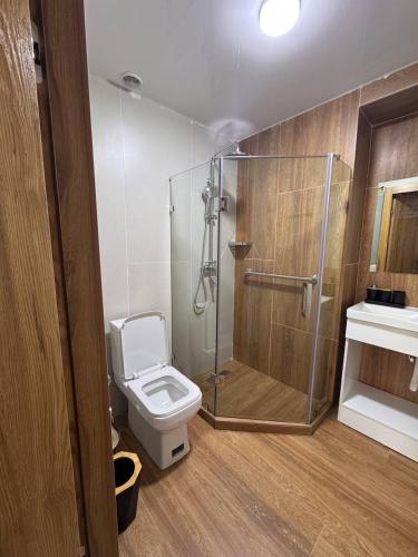 a bathroom with a shower and a toilet and a sink at Orient Lux in Yakkasaray