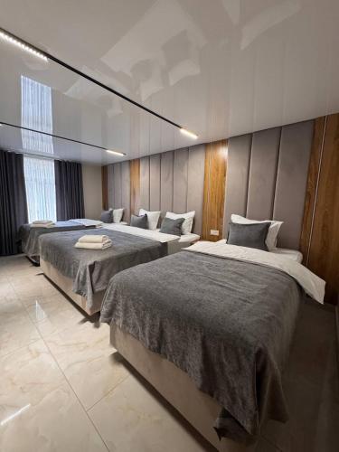 a bedroom with two beds in a room at Orient Lux in Yakkasaray
