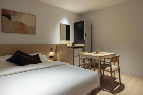 a hotel room with a bed and a table at Anook Hotel Jungangro Station in Daejeon
