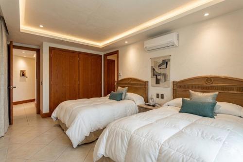 a hotel room with two beds in a room at Bay View Grand Ixtapa Exclusive in Ixtapa