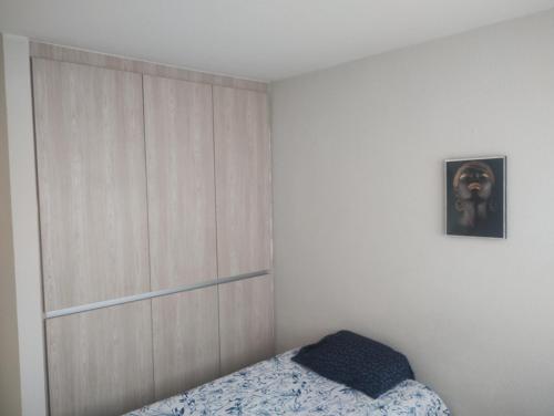 a bedroom with a bed and a wooden wall at Casa Lulu junto a Queretaro in Apaseo el Grande