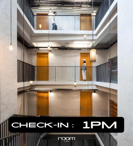 a person standing on a staircase in a building at Luk Hostel in Bangkok