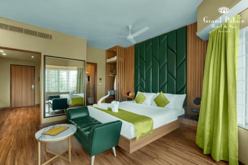 a bedroom with a bed and a green wall at Grand Palace Hotel & Spa in Yercaud