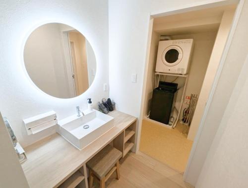 a bathroom with a sink and a mirror at muniyuitsu 宮古島 spa&park in Miyako-jima