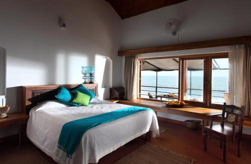 a bedroom with a bed with a view of the ocean at 36 Palms Boutique Retreat in Cherai Beach