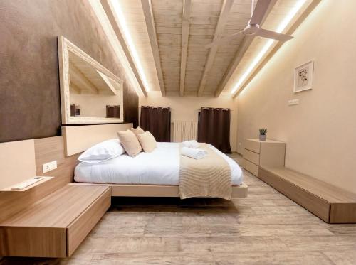 a bedroom with a large bed and a ceiling at Iseo Lake Luxury Duplex - Centro & Design in Iseo