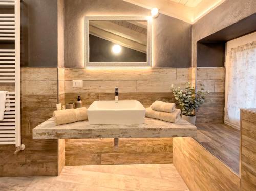 a bathroom with a sink and a mirror at Iseo Lake Luxury Duplex - Centro & Design in Iseo