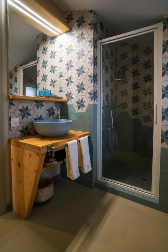 a bathroom with a sink and a glass shower at Locanda del Viandante Osco in Faido