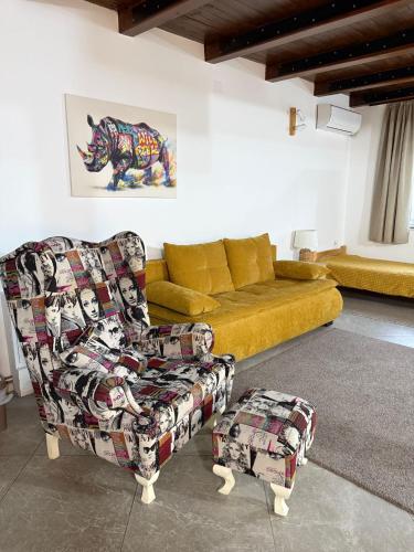 a living room with a couch and a chair at SOBE AVA in Palić