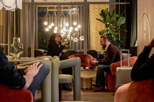 a group of people sitting in a waiting room at The Cloud One Frankfurt-Metropolitan in Frankfurt