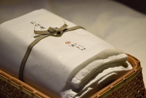 a cake with a hand on it in a basket at Muromachi Yutone Kyokoyado in Kyoto