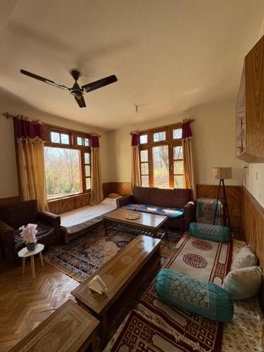 a living room with a couch and a table at Walking Trails homestay in Baragrān