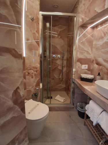 a bathroom with a shower and a toilet and a sink at Hotel Fiori in Rome