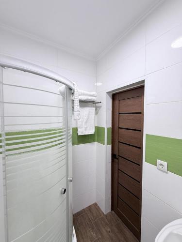 a bathroom with a shower and a sink at Orion Hotel in Almaty