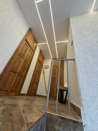a hallway with doors and a staircase in a building at City Retreat Arusha in Arusha