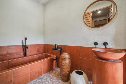 a bathroom with a wooden sink and a tub at Redbrick Villa By The Feelas in Bandung