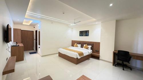 a hotel room with a bed and a desk at Hotel Parv Vilas in Behror