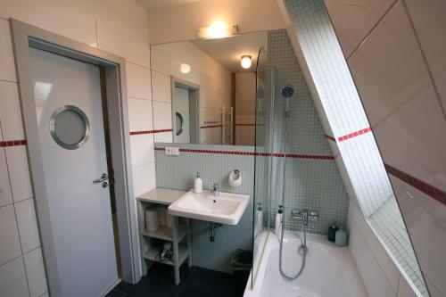 a bathroom with a sink and a tub and a mirror at Vila Krocinka in Prague