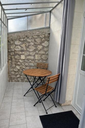 a table and two chairs sitting on a balcony at Maison de la Vallée - proche Zoo Beauval in Angé