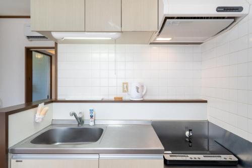 a kitchen with a sink and a counter top at Kent Clair Ishigaki Bay in Ishigaki Island