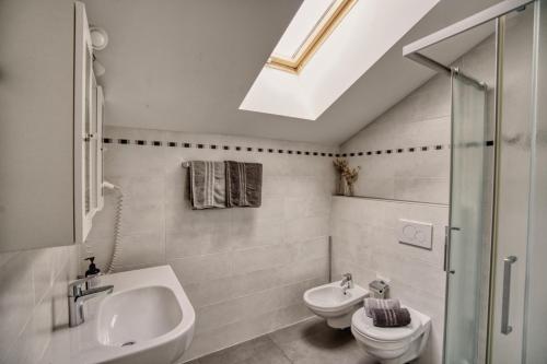 a bathroom with a sink and a toilet and a shower at byRosi Apartments in Parcines