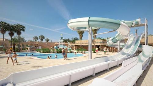 a water slide at a resort with a pool at Camping le Neptune in Argelès-sur-Mer
