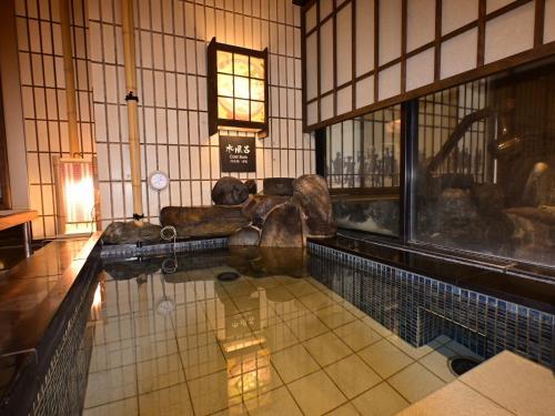 a room with a pool of water in a building at Dormy Inn Hakata Gion in Fukuoka