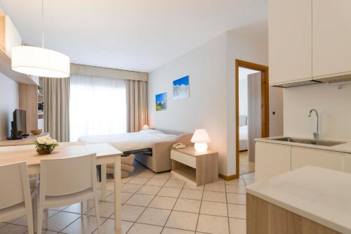a kitchen and living room with a bed and a table at Residenza Del Sole in Gressoney-Saint-Jean