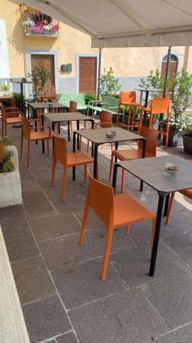 a group of tables and chairs on a patio at Moderno Albergo Didattico in San Pellegrino Terme