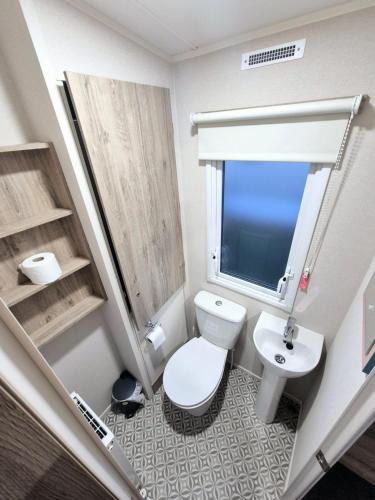 a small bathroom with a toilet and a sink at Birchington Vale - Trieste Sleeps 6 in Westgate-on-Sea