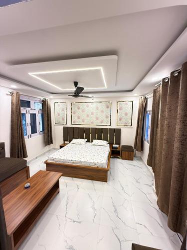 a living room with two beds and a couch at SanjayHomestay in Rāmpur