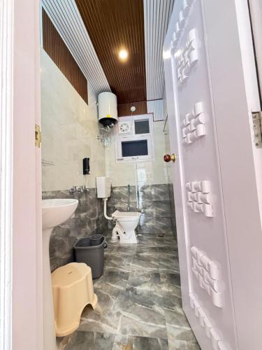 a bathroom with a sink and a toilet at SanjayHomestay in Rāmpur