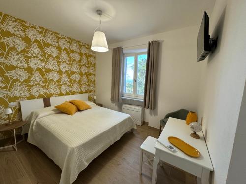 a bedroom with a bed and a table and a window at Agriturismo Belfiore in Castelnuovo Magra
