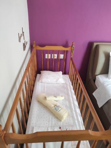 a crib with a remote control on top of it at Stefania's Luxury House in Platamonas