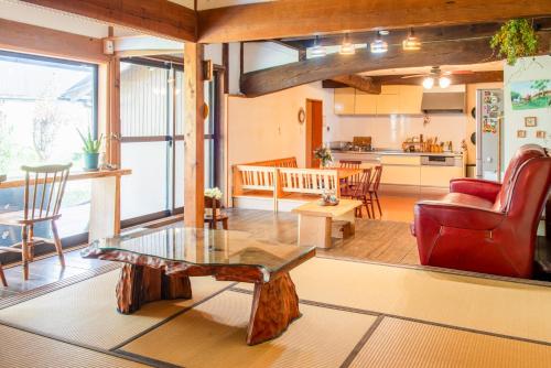 a living room with a red couch and a table at Mountain Home - One Hour From Osaka in Uda