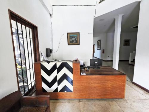 an office with a desk in the middle of a room at Casa Palma by Ezzego in Bandung