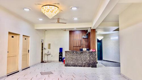 a lobby with a reception desk and a chandelier at Hotel Divine in Faridabad