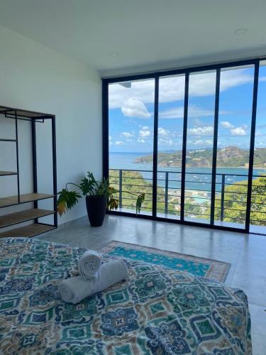 a bedroom with a bed with a view of the ocean at Casa Elio - Bed and Breakfast in San Juan del Sur