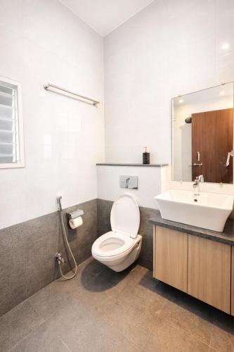 a bathroom with a toilet and a sink at LaBelle Haven Aesthetic Cozy 2BHK For Family and Couples in Indore