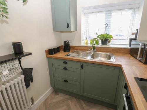 a small kitchen with a sink and a window at 2 Low Road in Bishop Auckland