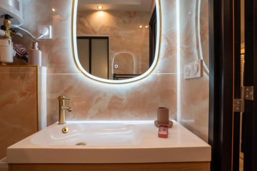 a bathroom with a sink and a mirror at La vie en rose in Grasse